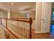 Upstairs hallway showcasing nice wood flooring and white railings at 6310 Talking Tree Ct, Cumming, GA 30028