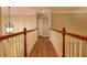 Upstairs hallway with a view overlooking the living room at 6310 Talking Tree Ct, Cumming, GA 30028