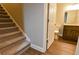 Carpeted stairs and hallway leading to a bathroom with a wooden vanity at 6310 Talking Tree Ct, Cumming, GA 30028