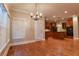 Bright open kitchen with an island, stainless appliances, and hardwood flooring, connecting to dining area at 6310 Talking Tree Ct, Cumming, GA 30028
