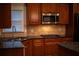 Stylish kitchen showcasing granite counters, tile backsplash, and updated stainless appliances at 6310 Talking Tree Ct, Cumming, GA 30028