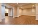 Open layout with wood flooring and view into an adjacent bathroom with vanity sink at 6310 Talking Tree Ct, Cumming, GA 30028