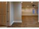 Open-plan living room featuring wood flooring, neutral walls, and view to bright, airy space at 6310 Talking Tree Ct, Cumming, GA 30028