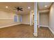 Bright living room with wood floors, neutral walls, ceiling fan and modern recessed lighting at 6310 Talking Tree Ct, Cumming, GA 30028