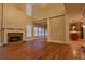 Open living space with fireplace, large windows, and seamlessly connects to the modern kitchen at 6310 Talking Tree Ct, Cumming, GA 30028