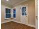Living room with wood floors, natural light, and access to the home's exterior at 6310 Talking Tree Ct, Cumming, GA 30028