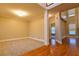 Open-concept living room with hardwood floors, carpeted area, and natural lighting at 6310 Talking Tree Ct, Cumming, GA 30028