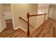 View of the staircase with wood handrail and flooring leading to a carpeted area at 6310 Talking Tree Ct, Cumming, GA 30028