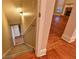 Carpeted staircase leading to a lower level, view of the hardwood living room at 6310 Talking Tree Ct, Cumming, GA 30028