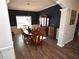 Formal dining room with hardwood floors, dark walls, and a large chandelier at 6440 Vista Crossing Way, Cumming, GA 30028