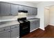 Modern kitchen with gray cabinets and black appliances at 6210 Winston Trce, Mcdonough, GA 30252