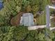 Stunning aerial view of the home showcasing its lush surroundings, patio, and landscaped yard at 9070 Huntcliff Trce, Sandy Springs, GA 30350