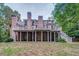 Expansive backyard featuring a spacious deck perfect for outdoor dining and entertainment with mature trees at 9070 Huntcliff Trce, Sandy Springs, GA 30350