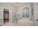Luxurious bathroom with a soaking tub under a window and a glass-enclosed shower with marble surround at 9070 Huntcliff Trce, Sandy Springs, GA 30350