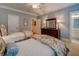 Bedroom with two twin beds and dresser featuring carpeted floors and natural light from a window at 9070 Huntcliff Trce, Sandy Springs, GA 30350