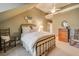 Cozy bedroom with neutral tones, carpet, a ceiling fan, and a wrought iron bed frame at 9070 Huntcliff Trce, Sandy Springs, GA 30350