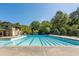 Large, inviting community pool with multiple lanes, surrounded by lush greenery and a pool house at 9070 Huntcliff Trce, Sandy Springs, GA 30350