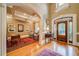Grand foyer showcasing hardwood floors, high ceilings, and a decorative front door at 9070 Huntcliff Trce, Sandy Springs, GA 30350