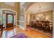 Elegant foyer with hardwood floors, a decorative front door, and view into the dining room at 9070 Huntcliff Trce, Sandy Springs, GA 30350