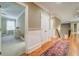 Hallway with hardwood floors and doors leading to bedrooms and stairs at 9070 Huntcliff Trce, Sandy Springs, GA 30350