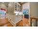 Hallway featuring hardwood floors and a built-in china cabinet that leads into the kitchen at 9070 Huntcliff Trce, Sandy Springs, GA 30350