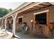Exterior view of horse stalls and the structure of the building with horses peering out of the stalls at 9070 Huntcliff Trce, Sandy Springs, GA 30350