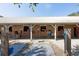 A horse barn featuring multiple stalls with wooden doors and metal roofing on a farm or ranch property at 9070 Huntcliff Trce, Sandy Springs, GA 30350