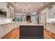 A bright kitchen features stainless appliances, a center island with sink, and views to the living room at 9070 Huntcliff Trce, Sandy Springs, GA 30350