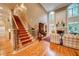 Spacious living room featuring a fireplace and large windows with an adjacent staircase at 9070 Huntcliff Trce, Sandy Springs, GA 30350