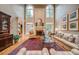 Bright living room featuring a fireplace and large windows, furnished with a sofa and chairs at 9070 Huntcliff Trce, Sandy Springs, GA 30350