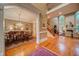 Open-concept living space with a dining room view, hardwood floors, and fireplace at 9070 Huntcliff Trce, Sandy Springs, GA 30350
