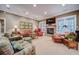 Living room with stone fireplace, lots of seating and view of the backyard at 9070 Huntcliff Trce, Sandy Springs, GA 30350