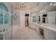 The luxurious main bathroom has marble floors, double vanities, a tub, and plenty of space at 9070 Huntcliff Trce, Sandy Springs, GA 30350