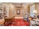 Cozy office with custom bookshelves, hardwood floors, and natural light at 9070 Huntcliff Trce, Sandy Springs, GA 30350