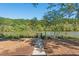 Scenic riverfront view with a charming walking path leading to a private gate and serene water at 9070 Huntcliff Trce, Sandy Springs, GA 30350
