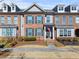 Brick front exterior of charming townhome with gray accents and landscaping at 256 S Village Sq, Canton, GA 30115