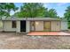 Back exterior of home, with large backyard, white siding, black trim, and patio at 1428 Muirfield Dr, Stone Mountain, GA 30088