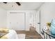 Bedroom featuring wood-look floors, a closet, and freshly painted white walls at 1428 Muirfield Dr, Stone Mountain, GA 30088