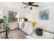 Cozy bedroom with a ceiling fan, large window, and stylish decor on a plush area rug at 1428 Muirfield Dr, Stone Mountain, GA 30088