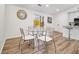 Cozy dining area with a glass table, modern chairs, and convenient access to the kitchen at 1428 Muirfield Dr, Stone Mountain, GA 30088