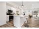 Modern kitchen featuring white cabinets, stainless steel appliances, and a breakfast bar at 1428 Muirfield Dr, Stone Mountain, GA 30088