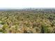 Scenic aerial view of a neighborhood surrounded by lush greenery, with Atlanta skyline in distance at 6 Arden Moor Nw, Atlanta, GA 30305