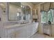 Elegant bathroom with dual sinks, decorative mirrors, and patterned wallpaper at 6 Arden Moor Nw, Atlanta, GA 30305
