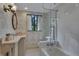 Updated bathroom with tub/shower combination, marble countertop and a large mirror at 6 Arden Moor Nw, Atlanta, GA 30305