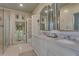 Bright bathroom featuring double sinks, neutral colors, and a glass-enclosed shower at 6 Arden Moor Nw, Atlanta, GA 30305