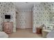 Cozy bedroom featuring an arm chair, patterned wallpaper and built-in storage at 6 Arden Moor Nw, Atlanta, GA 30305