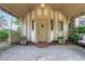 Front entrance with covered porch, decorative details, and manicured plants at 6 Arden Moor Nw, Atlanta, GA 30305