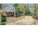 Front exterior of estate with a portico, gravel driveway, and decorative bushes at 6 Arden Moor Nw, Atlanta, GA 30305