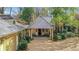 Front exterior of estate with a portico, gravel driveway, and manicured landscaping at 6 Arden Moor Nw, Atlanta, GA 30305