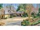 Exterior facade of estate with circular driveway and decorative topiaries at 6 Arden Moor Nw, Atlanta, GA 30305